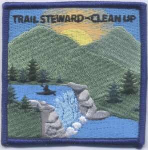 Trail steward clean up patch with mountains, river, and kayaker